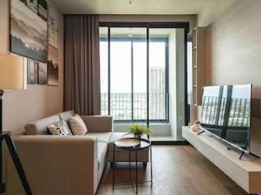 Modern living room with floor-to-ceiling windows and a cozy couch