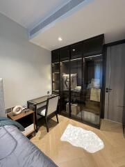 Modern bedroom with a work desk and glass wardrobe