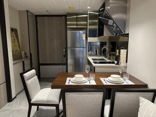 Modern kitchen area with dining table and appliances