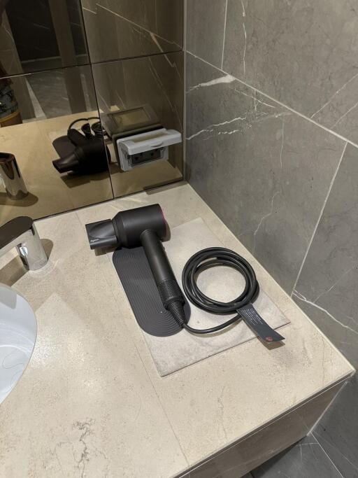 Bathroom countertop with hairdryer and mirror