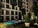 Night view of apartment building with outdoor pool