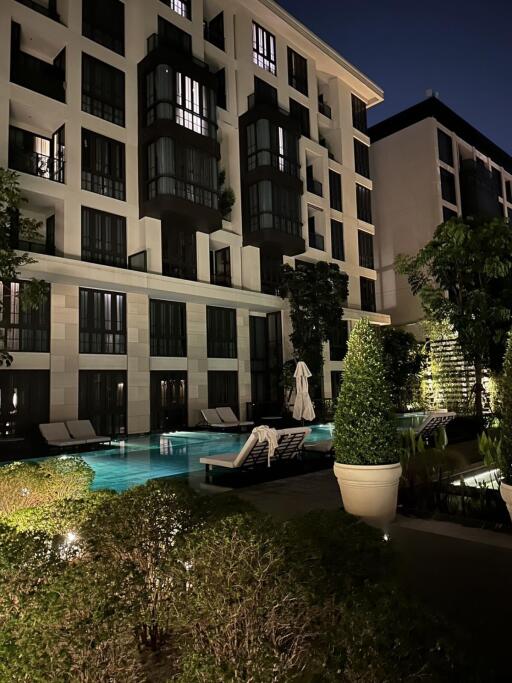 Night view of apartment building with outdoor pool