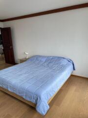 Room with bed and wooden floor