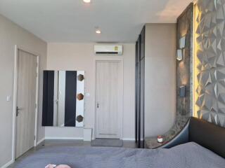 Modern bedroom with unique geometric wall design and air conditioning