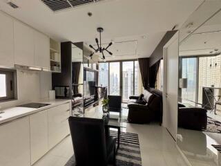 Modern living room with kitchenette and city view