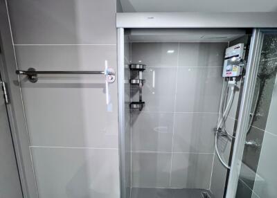 Shower area with glass door and towel rack