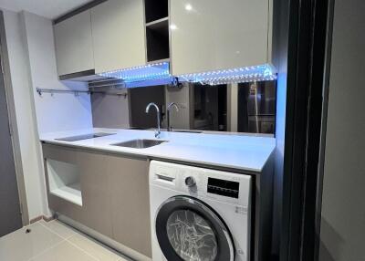 Modern kitchen with built-in cabinets and washing machine