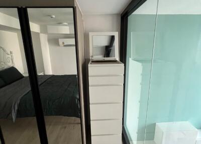 Modern bedroom with large mirrored wardrobe and floor-to-ceiling window