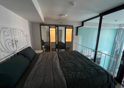 Modern bedroom with large bed and mirrored wardrobe