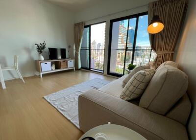 Modern living room with a large window and city view