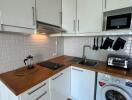 Modern Kitchen with wooden countertop and white cabinetry