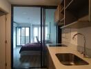 Modern kitchen with view of a bedroom in the background