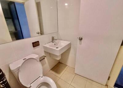 Modern bathroom with white fixtures and tiled walls