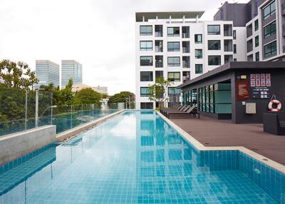 Outdoor swimming pool with apartment building