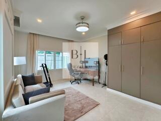 Spacious bedroom with built-in wardrobe and study area