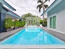 Outdoor pool with surrounding greenery and modern house