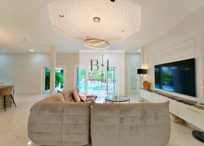 Spacious and bright living room with modern furnishings and stylish lighting