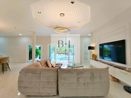 Spacious and bright living room with modern furnishings and stylish lighting