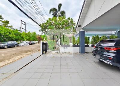 Outdoor area with parking space and greenery