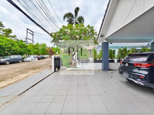 Outdoor area with parking space and greenery