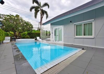 Swimming pool beside a modern house with a backyard