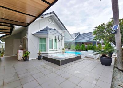 Modern outdoor patio area with seating and pool