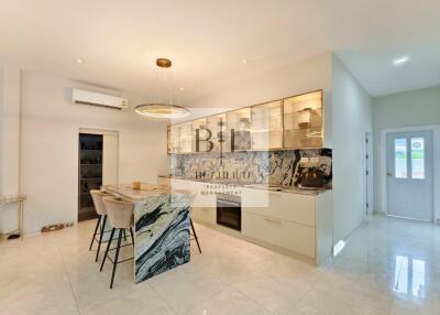 Modern kitchen with marble island and pendant light