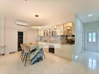 Modern kitchen with marble island and pendant light