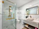 Modern bathroom with glass shower, marble sink, and elegant fixtures