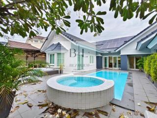 Outdoor view of property with swimming pool and garden