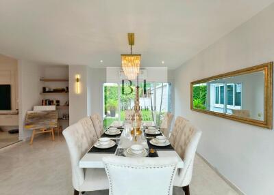 Elegant dining room with table set for a meal and modern chandelier