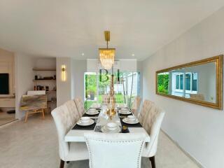 Elegant dining room with table set for a meal and modern chandelier