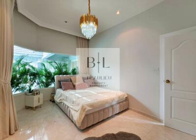 Modern bedroom with large window and chandelier