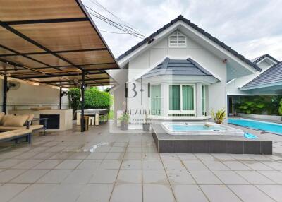 Outdoor area with covered seating, jacuzzi, and pool