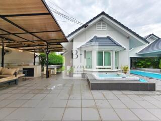 Outdoor area with covered seating, jacuzzi, and pool