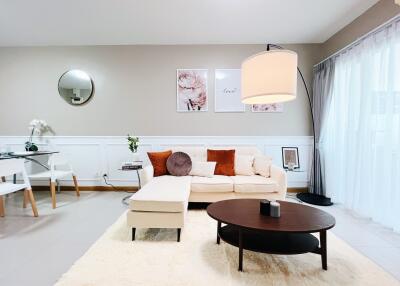 Modern living room with white sofa, coffee table, and stylish decor