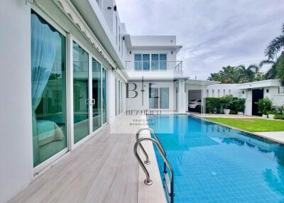 Modern house with a swimming pool and patio area