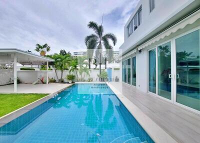 Outdoor area with swimming pool and adjoining building