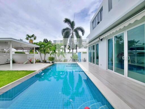 Outdoor area with swimming pool and adjoining building