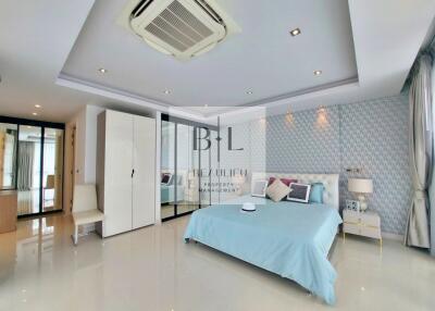 Spacious master bedroom with modern design and large windows