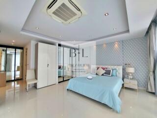 Spacious master bedroom with modern design and large windows