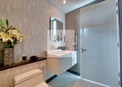 Modern bathroom with floating vanity and textured wall