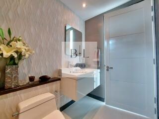 Modern bathroom with floating vanity and textured wall