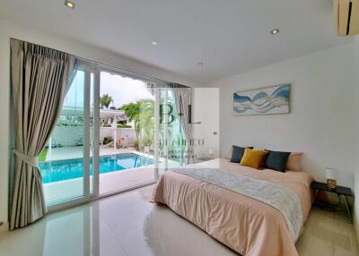 Bedroom with pool view and large glass sliding doors