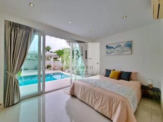 Bedroom with pool view and large glass sliding doors