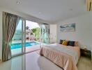 Bedroom with pool view and large glass sliding doors