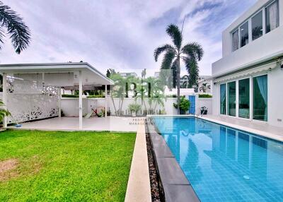 Swimming pool area with adjacent covered patio and building