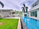 Swimming pool area with adjacent covered patio and building