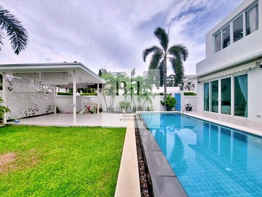 Swimming pool area with adjacent covered patio and building