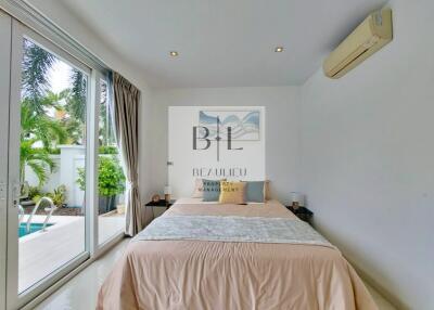 Modern bedroom with pool view and air conditioning